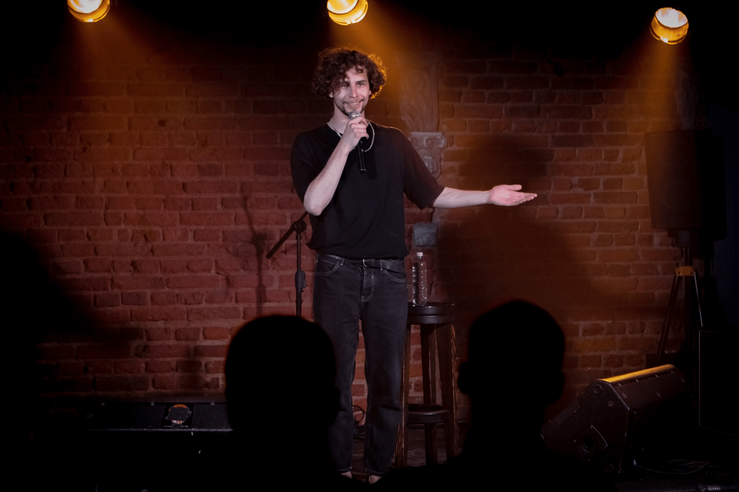 College student on a stage for an open mic comedy night