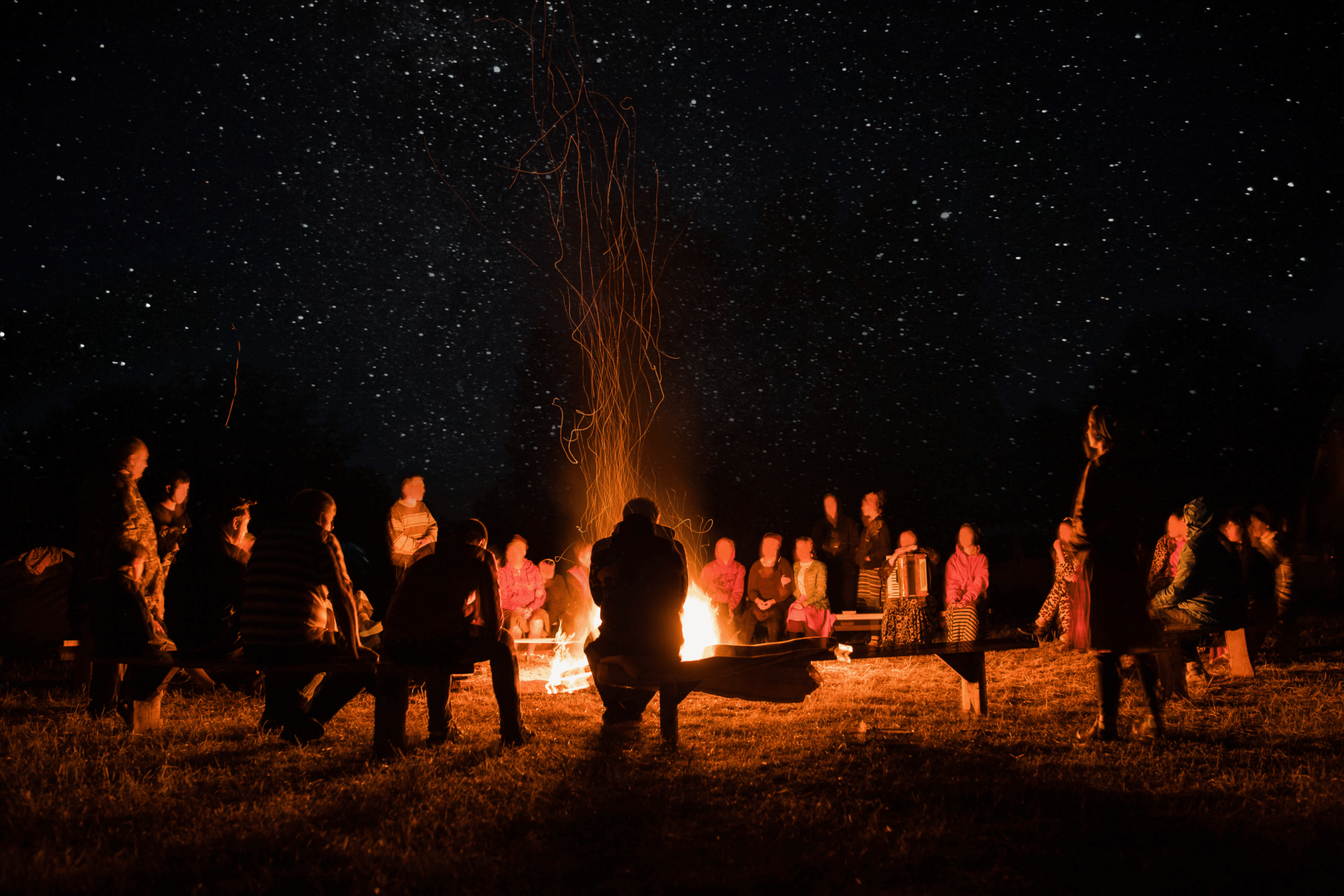 group of people gathered around a bonfire