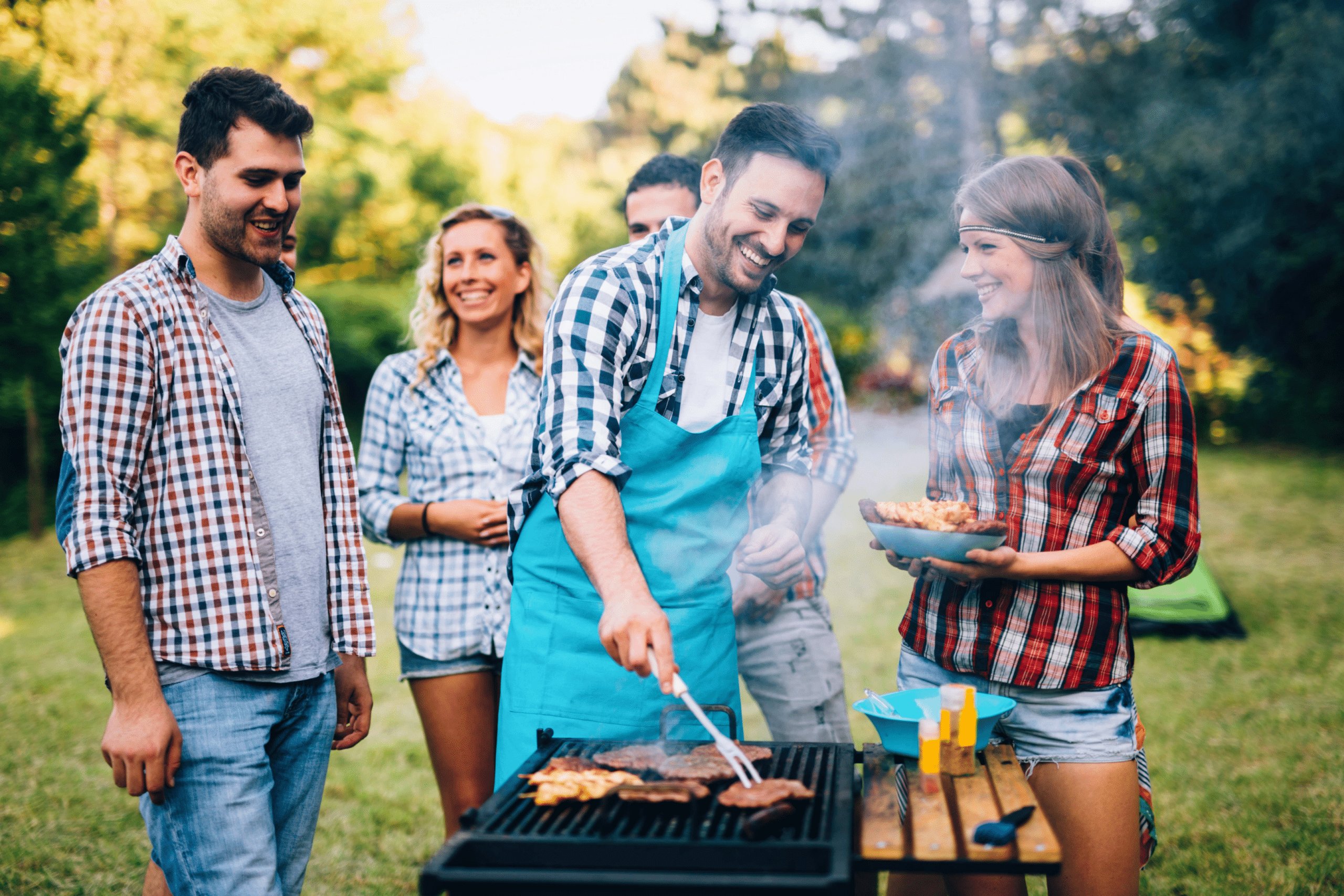 group of people grilling hamburgers outside