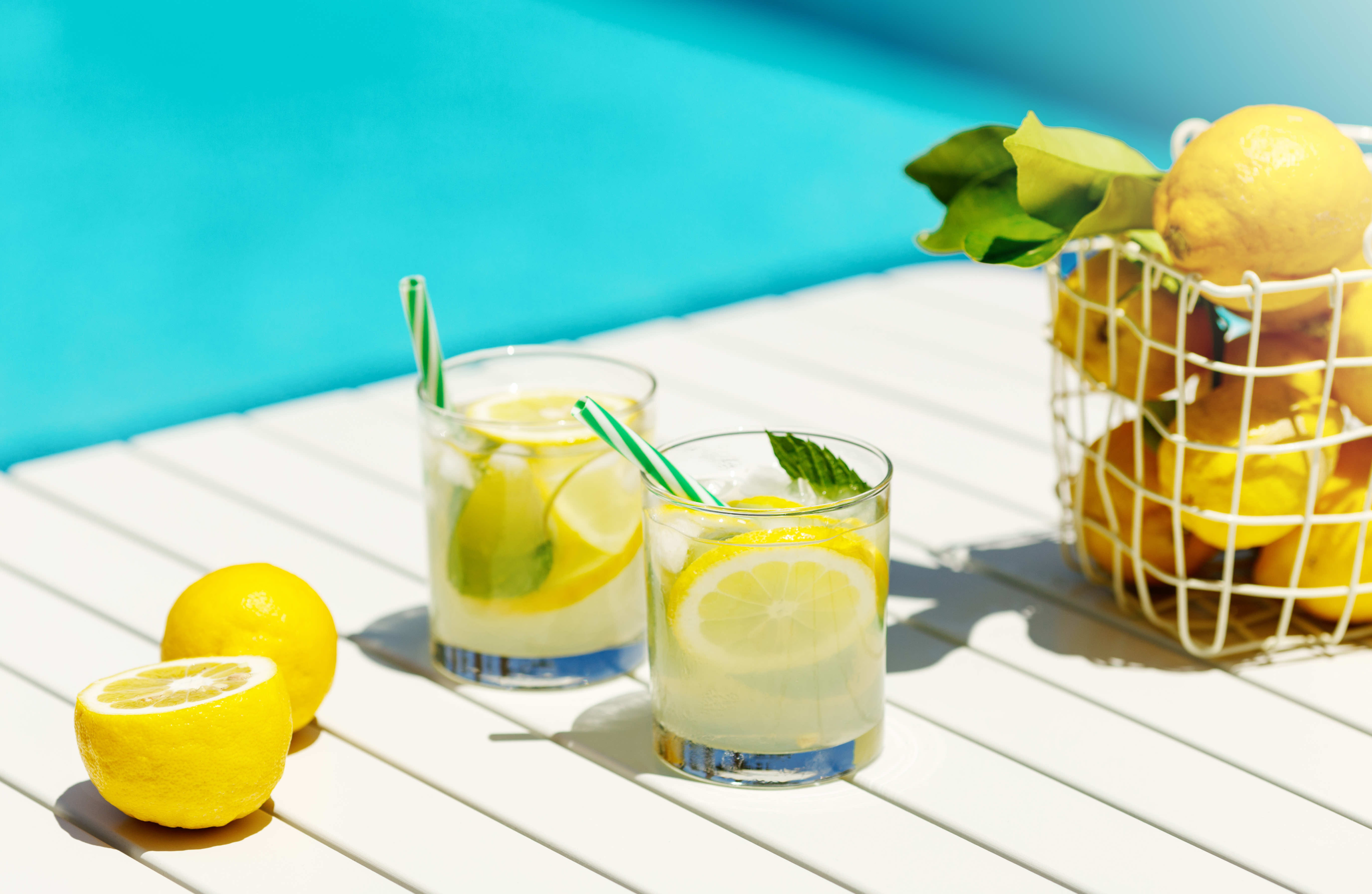 a table with two glasses of lemonade on it