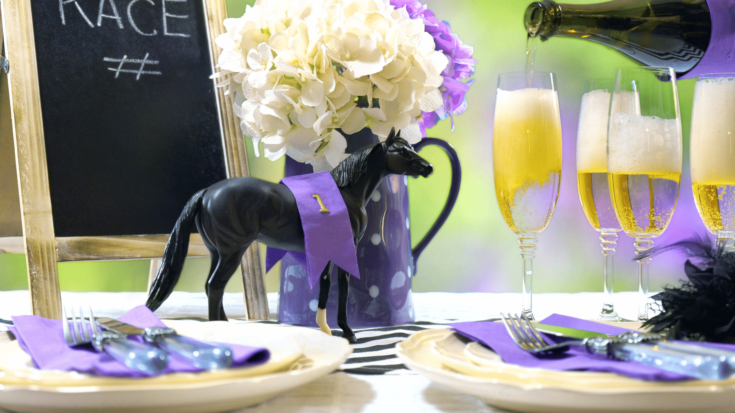 A table with party decorations of horses and purple ribbons