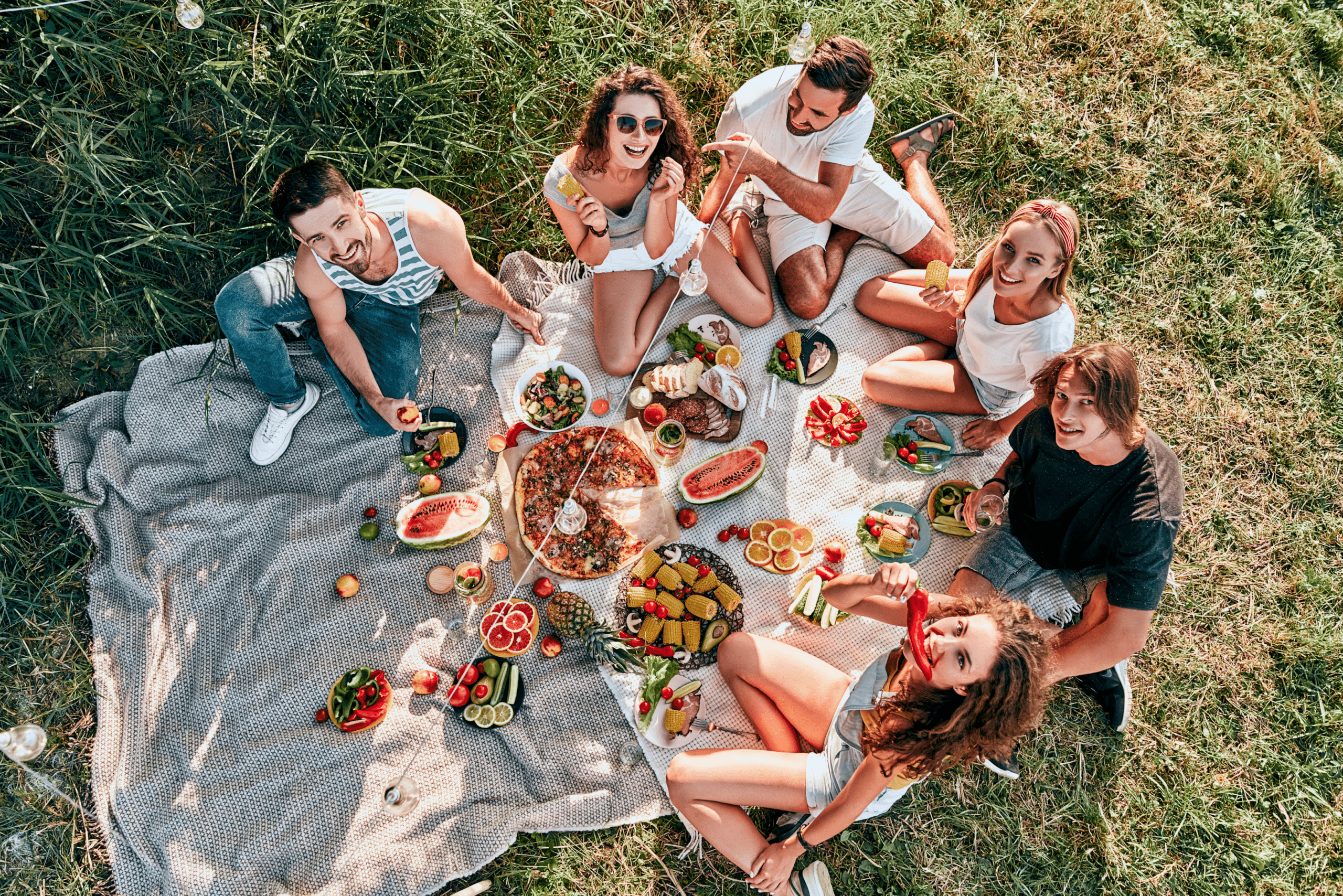 a group of people enjoying a big picnic outside