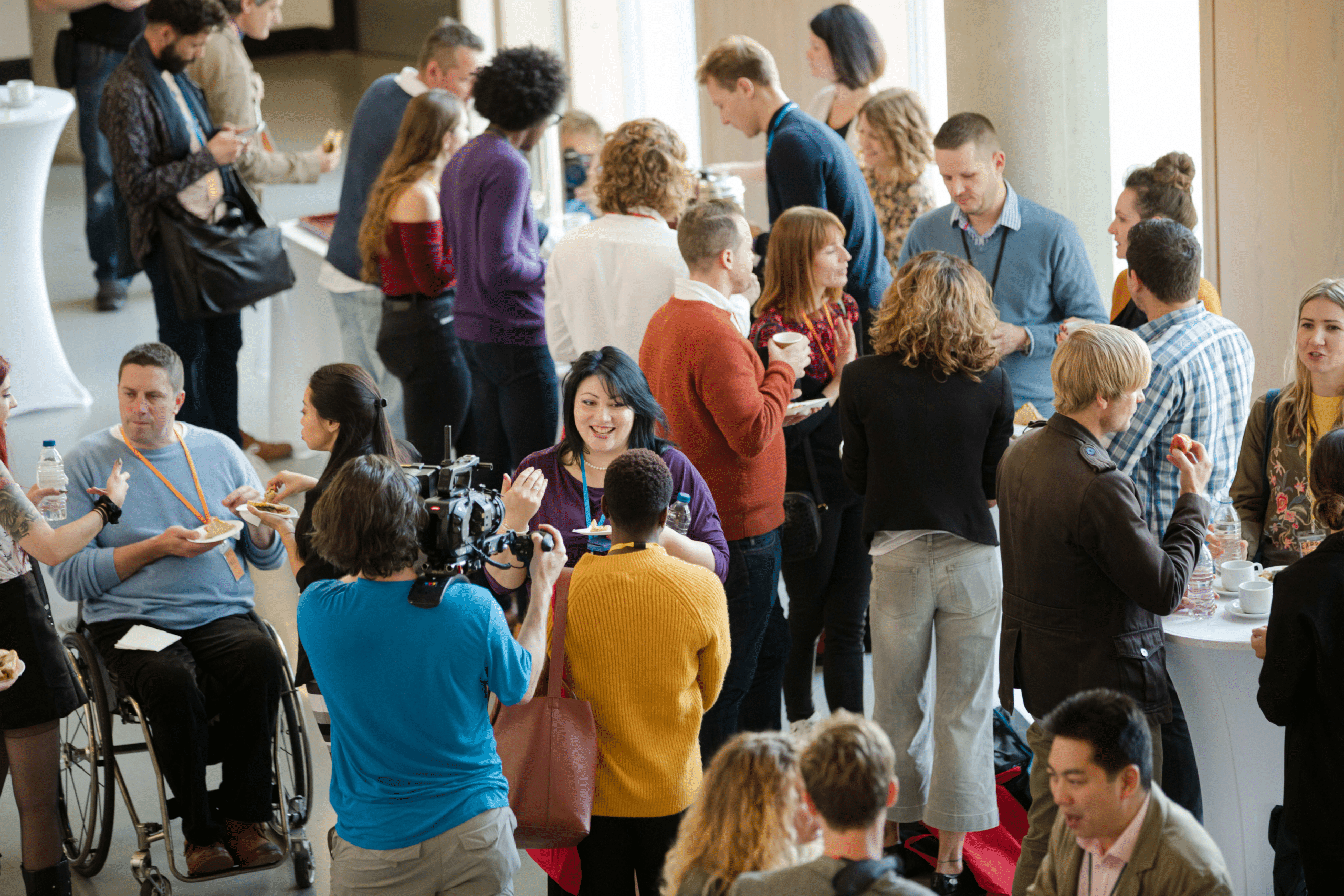 large group of event attendees talking at a conference