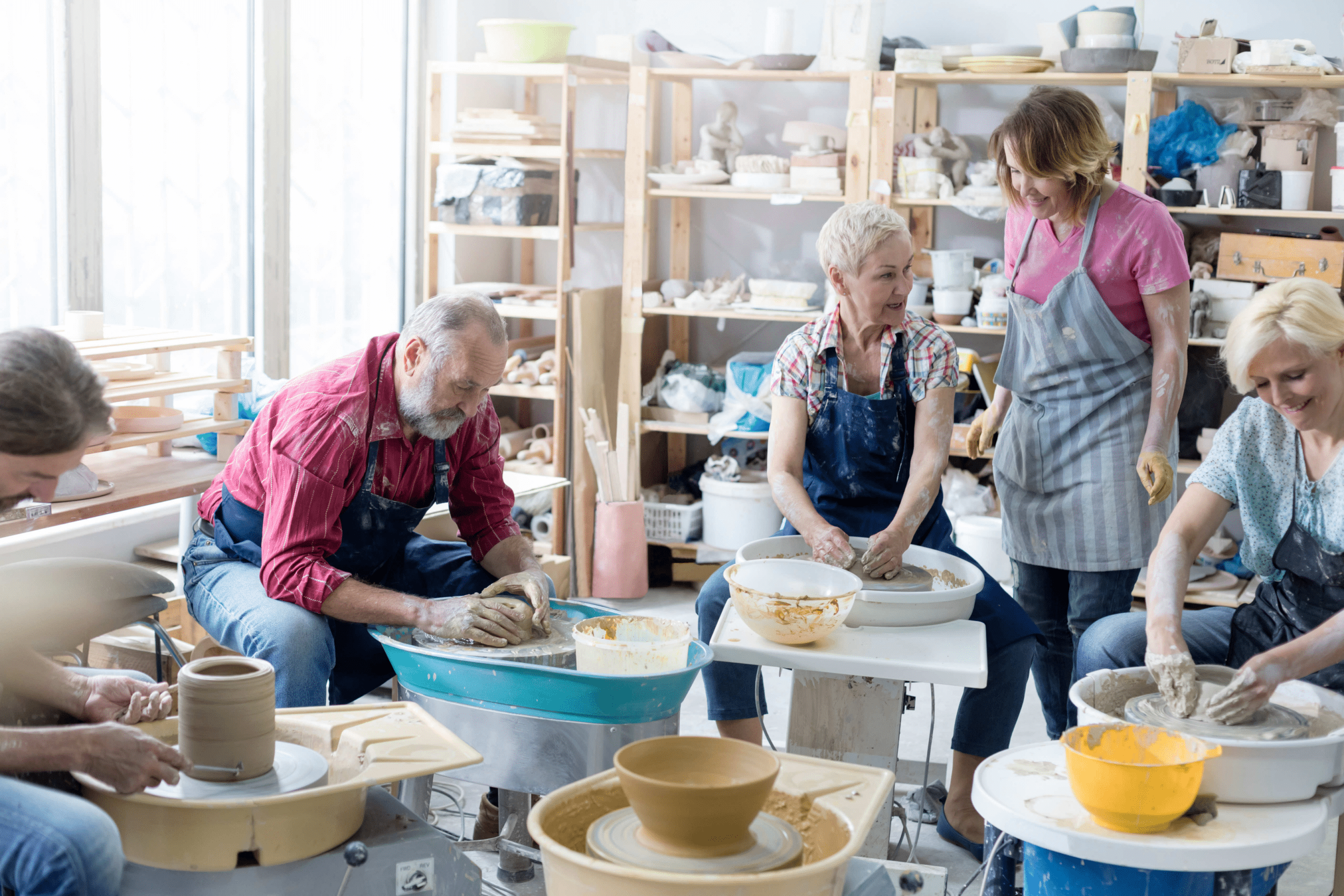 group of elderly people at a pottery workshop