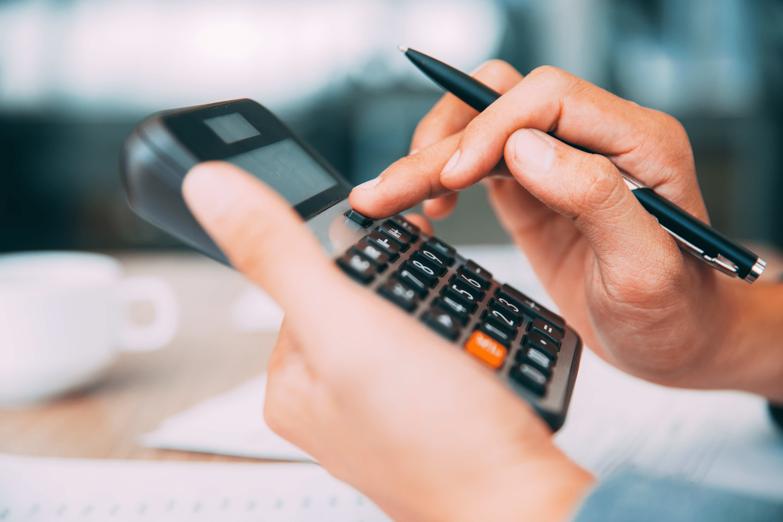 A person's hands crunching numbers on a calculator