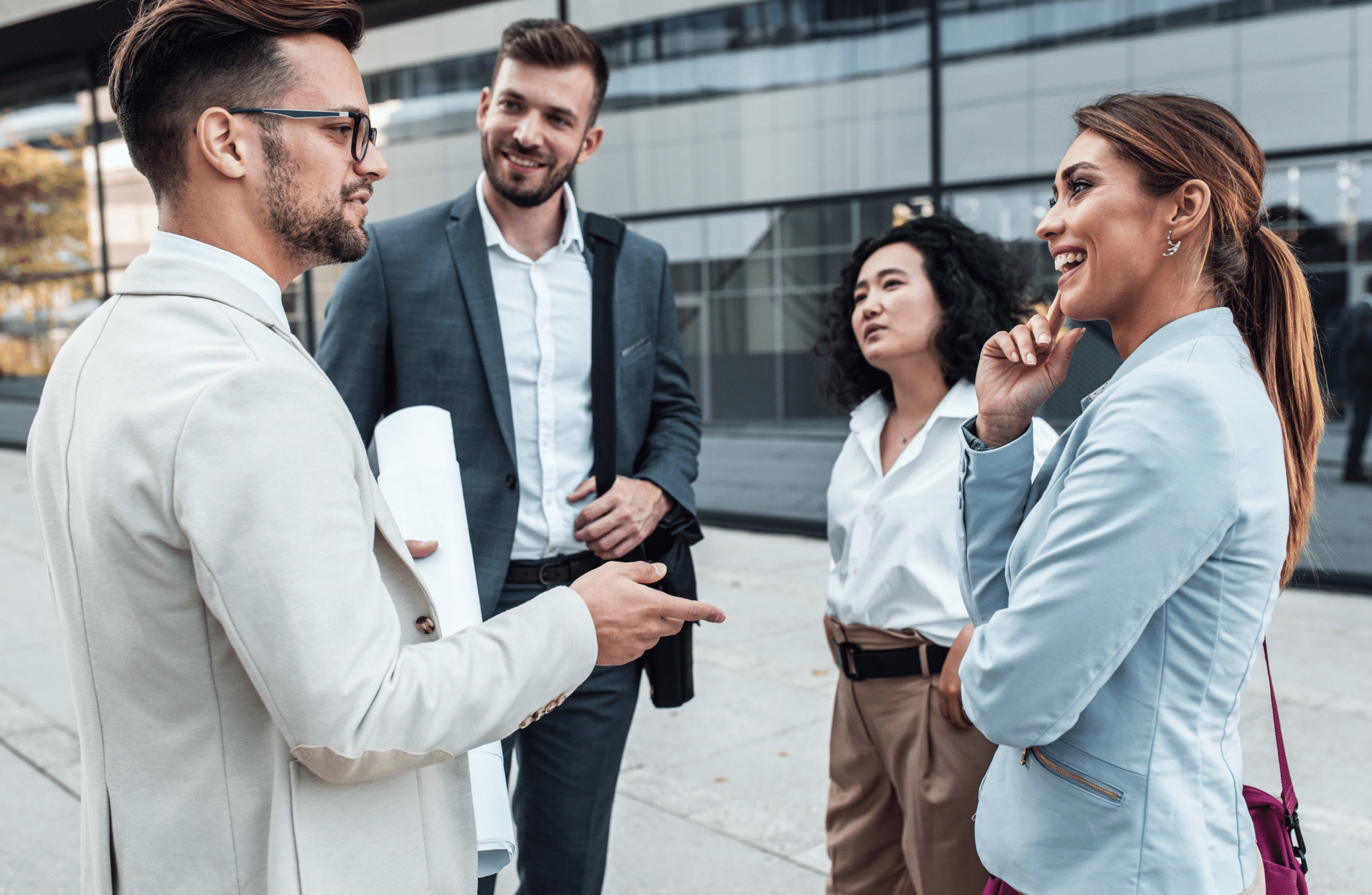 group of four people in business casual attire, networking at a workshop