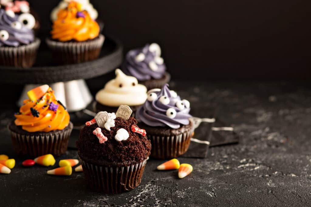Festive Halloween cupcakes and treats decorated with sprinkles and candy