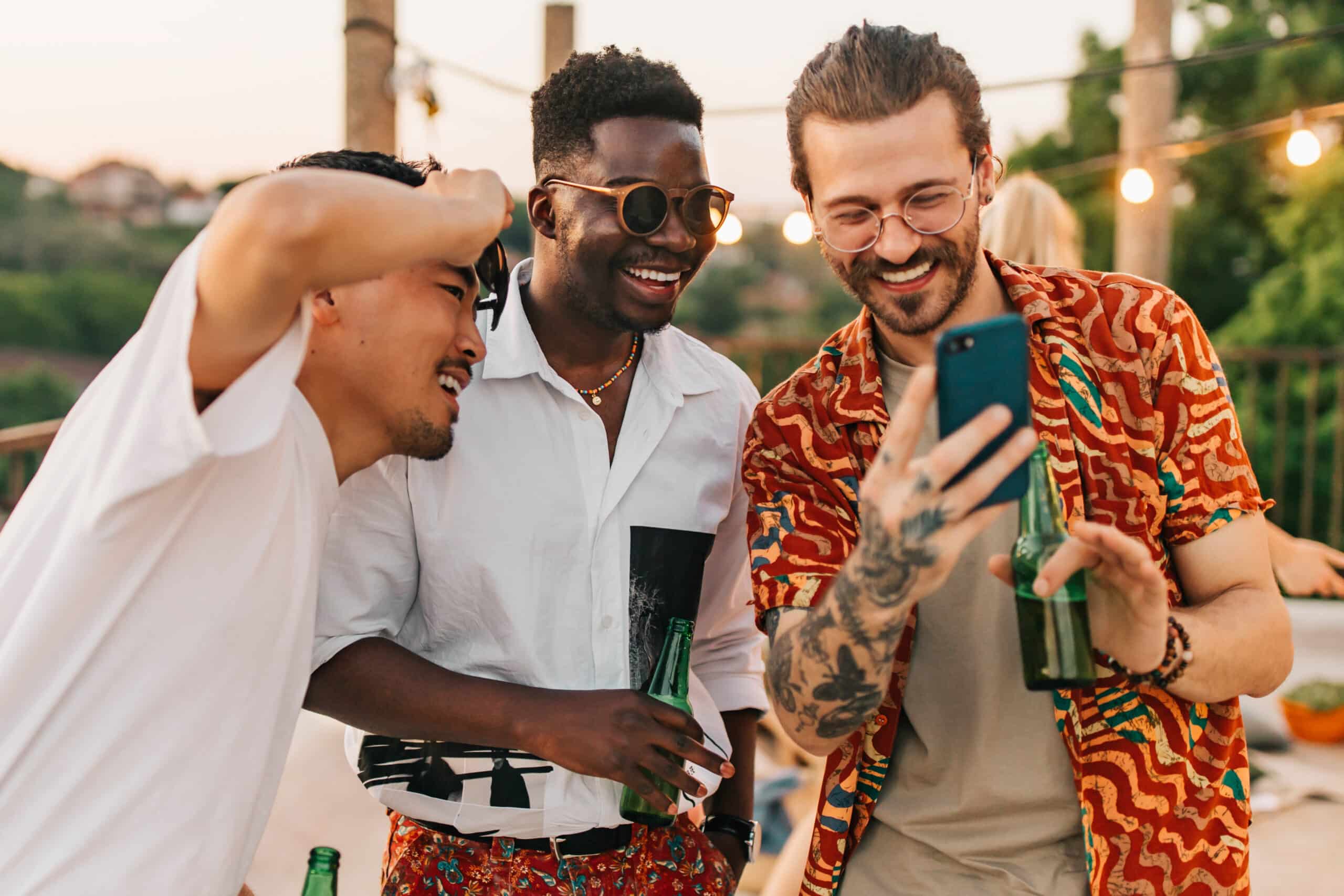 Friends are looking at the photos on the phone at the party