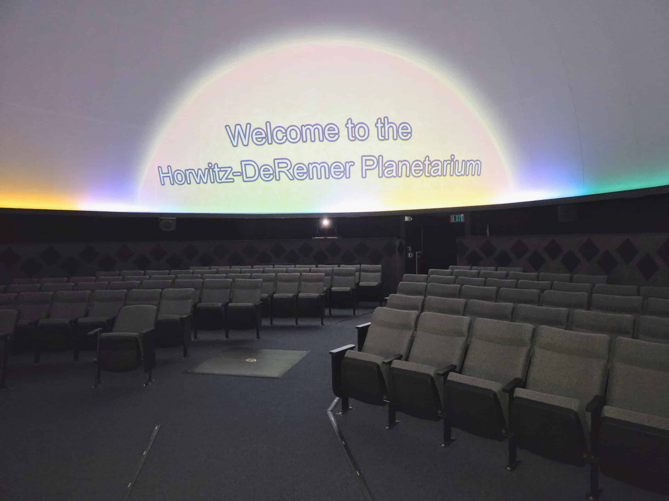 Horwitz-DeRemer Planetarium neon lights and branded welcome message in ceiling with viewing seats